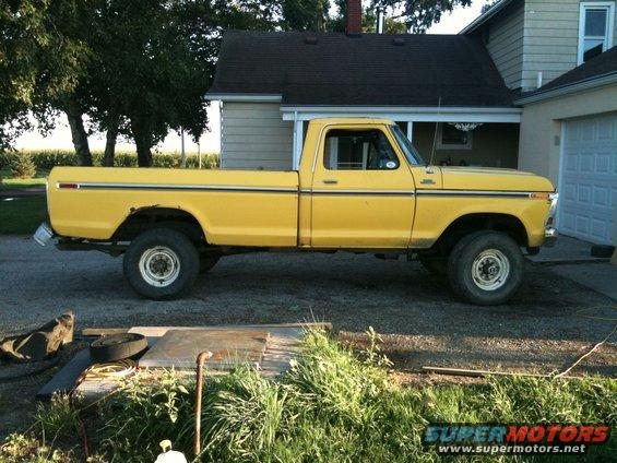 1978 Ford F-250 pickup truck parked in a driveway next to a house