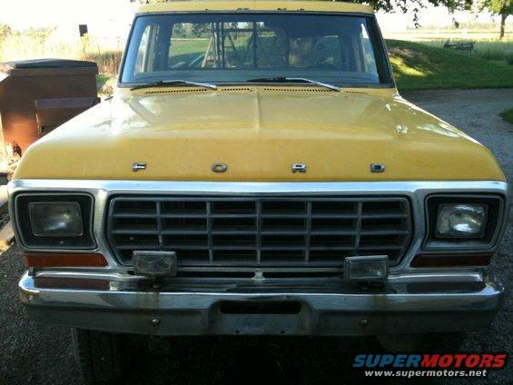 Front view of a yellow 1978 Ford F-250 pickup truck with a chrome grille and headlights
