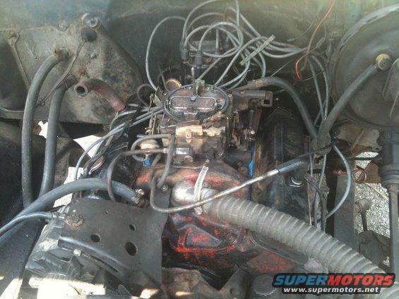 Engine bay with carburetor and tangled wiring