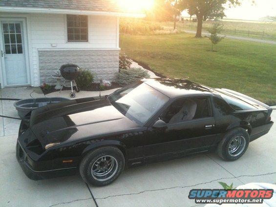 Black 1982 Chevrolet Camaro coupe with aftermarket wheels parked on a driveway