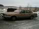 1990 Lincoln Town Car - A tan 1990 Lincoln Town Car is parked in a field with snow on the ground.