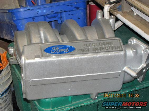 Ford electronic fuel injection intake manifold sitting on a green crate
