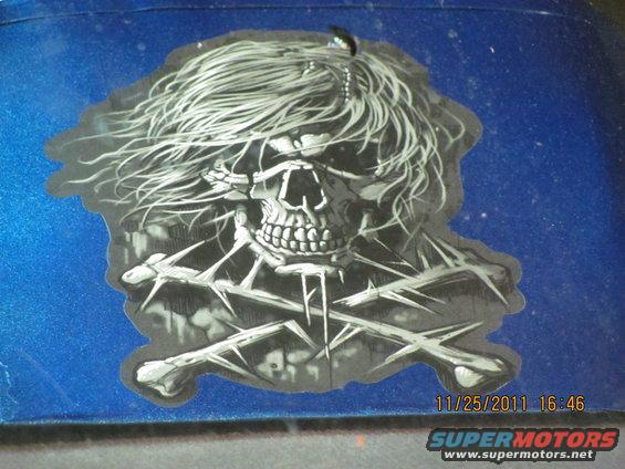 Skull and crossbones sticker on blue surface with date stamp