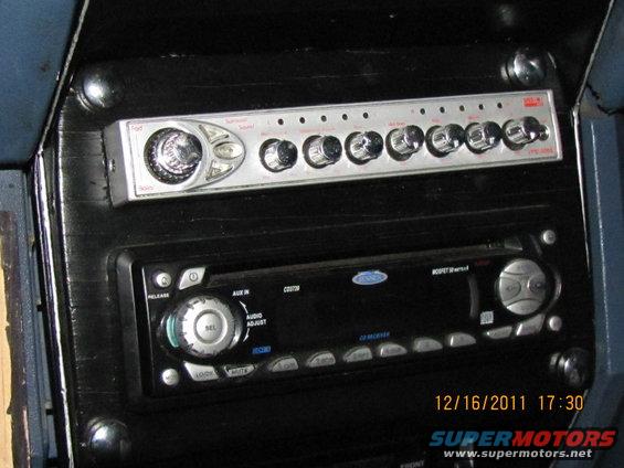 Aftermarket car stereo and equalizer mounted in a dashboard