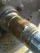 1995 Ford Bronco - Close-up view of a heavily worn axle shaft with damaged splines.