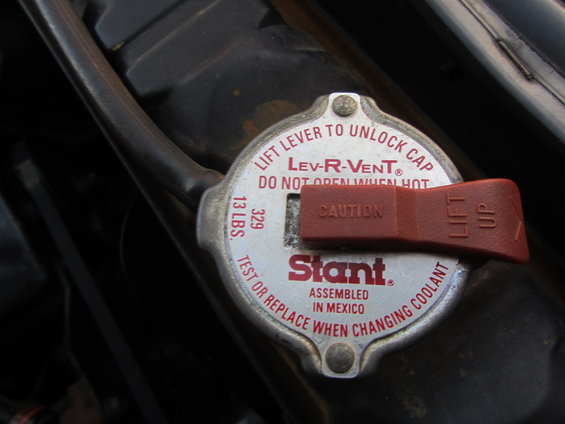 Radiator cap with red Lev-R-Vent lever, labeled 'Stant' and 'Assembled in Mexico'