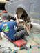 1994 Ford Bronco - Two mechanics are working on the rear suspension of a 1994 Ford Bronco.