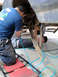 1994 Ford Bronco - Mechanics are working on the suspension system of a vehicle that is raised off the ground.