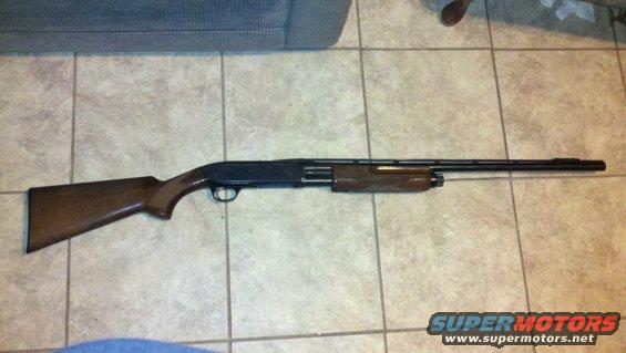 Wooden stock shotgun on tiled floor