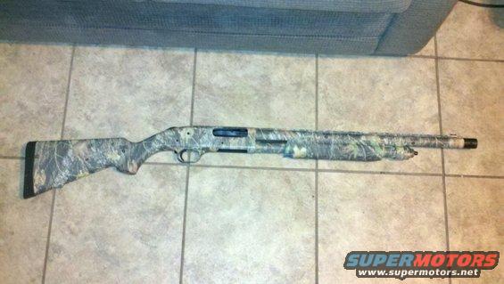 Camouflaged shotgun lying on tiled floor