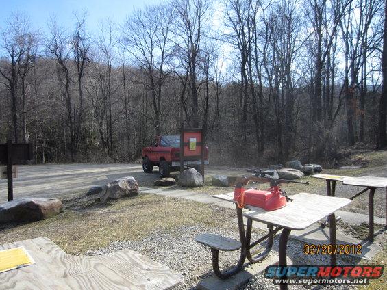 Red pickup truck parked near a picnic table and trees. Date stamp reads 02/20/2012