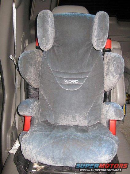 Gray Recaro car seat with red accents, seen from the front inside a vehicle