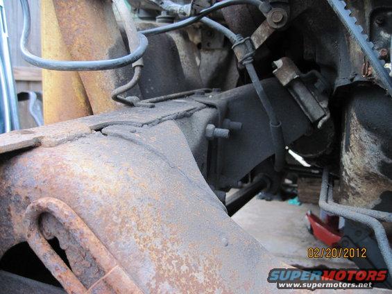 Rusted frame and engine components, close-up view