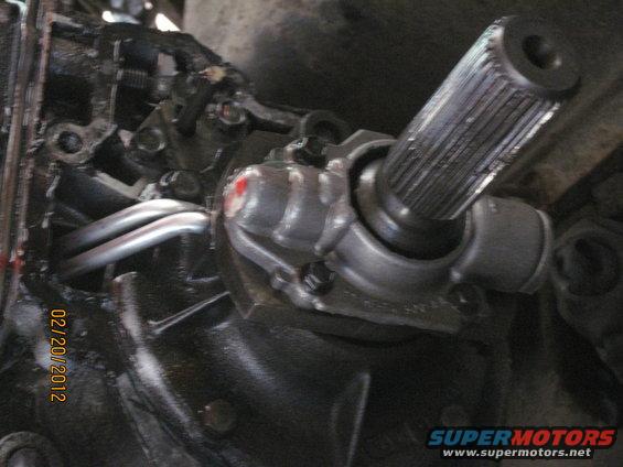 Close-up of a splined shaft connected to a metal housing with red paint marks