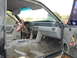 1987 Ford Mustang - The interior of a 1987 Ford Mustang shows signs of modification and wear, with exposed wiring and an aftermarket steering wheel.