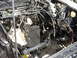 1987 Ford Mustang - The engine bay is exposed, revealing the car's internal components and wiring harness.