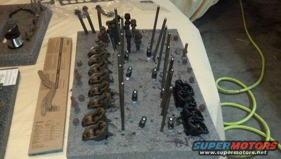 Engine valve train parts organized on foam board