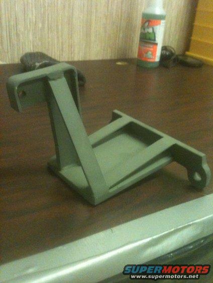 Gray metal bracket on a wooden surface