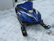 1987 Polaris Indy 600 - A blue snowmobile with white graphics and SRX branding sits on a snowy surface.