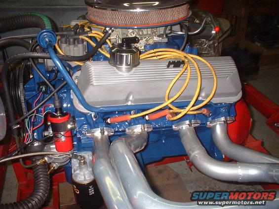Engine with silver valve covers and blue block, yellow spark plug wires