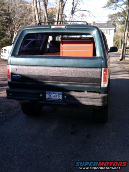 1992 Ford Bronco rear view, showing a toolbox in the cargo area. License plate reads DMC-8635