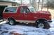 1990 Ford Bronco - This red Ford Bronco features a two-tone paint scheme and appears to be from the late 1980s.