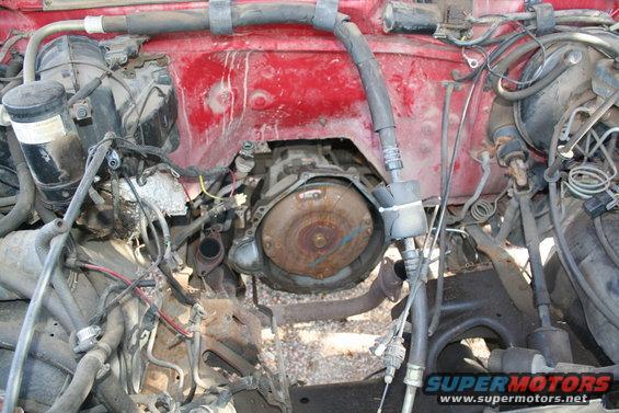engine bay with transmission visible, red firewall