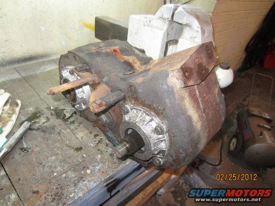 transfer case on a workbench, with a vise holding part of it