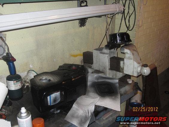 NP205 transfer case clamped in a vise, with spray paint and a torch nearby