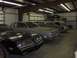 1976 Pontiac Trans Am - A black 1976 Pontiac Trans Am is parked in a garage alongside several other vehicles.
