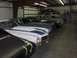 1976 Pontiac Trans Am - Multiple classic cars, including a 1976 Pontiac Trans Am, are stored in a garage.