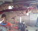 1972 Champion 181 SX - A red tractor with a blue seat and visible engine is stored in a garage, with items suspended from the ceiling.