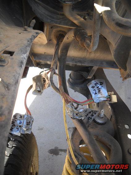 Close-up of vehicle wiring with tape labels. One label reads 'EVAP 92'