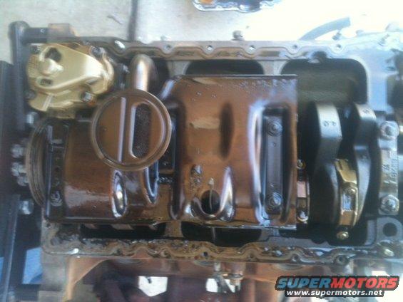 Engine oil pan removed, showing crankshaft and connecting rods