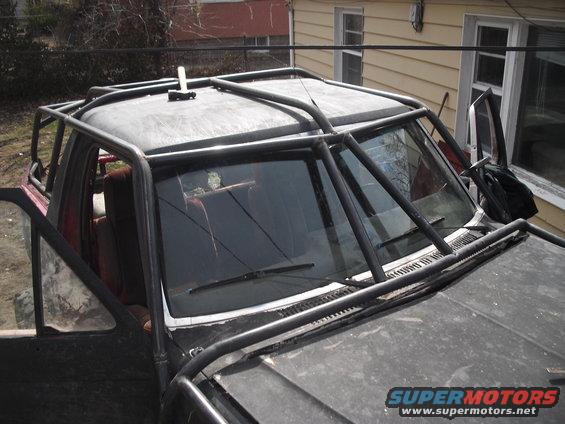 Truck with a full external roll cage and open doors