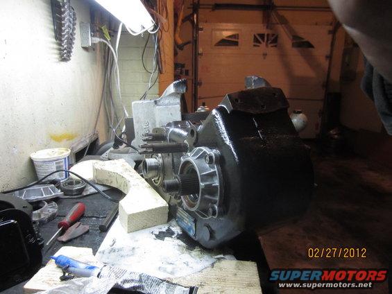 NP205 transfer case on a workbench with tools and parts