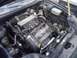 2003 Hyundai Tiburon - The engine bay of a car, showing the engine, supercharger, and various hoses and components.