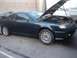 2003 Hyundai Tiburon - A dark blue 2003 Hyundai Tiburon is parked with its hood open, revealing the engine bay.