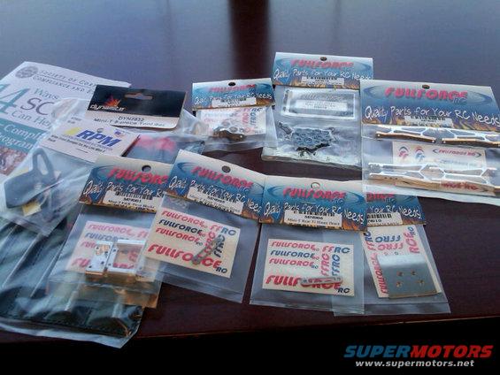 RC car parts in plastic packaging on a table