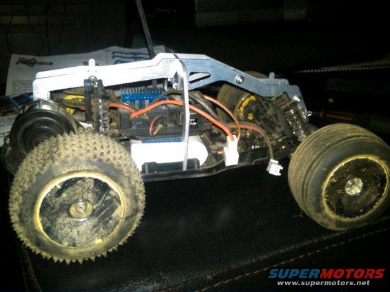 Remote control car chassis with exposed wiring and suspension components