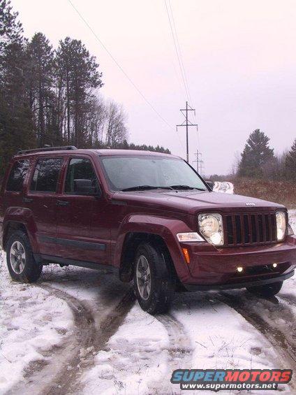 Maroon 2008 Jeep Liberty parked on a snowy road