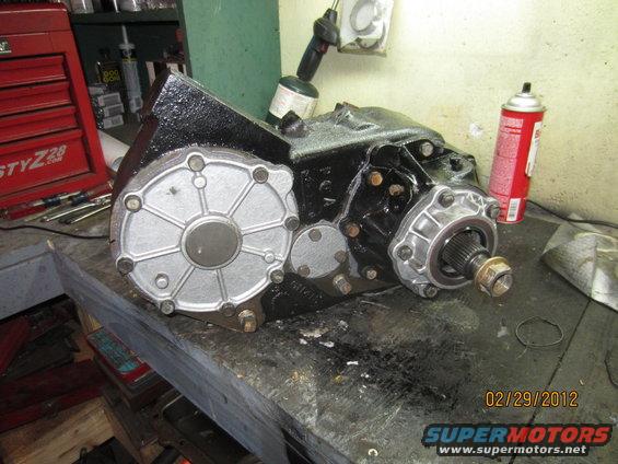 NP205 transfer case on a workbench with tools and spray cans nearby