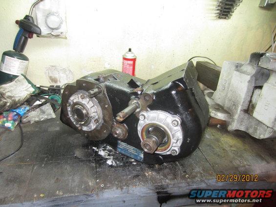 NP205 transfer case on a workbench with a propane torch nearby