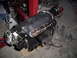 2003 Hyundai Tiburon - A supercharger assembly, likely for an engine, is shown with a throttle body and a length of chain.