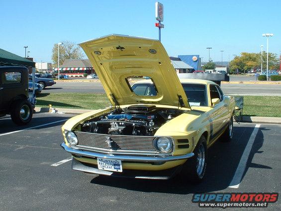 Yellow 1970 Ford Mustang Boss 302 with hood open, front view