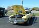 1995 Ford Crown Victoria - A yellow 1970 Ford Mustang Boss 302 is parked with its hood open, revealing the engine, in front of a Burger King.