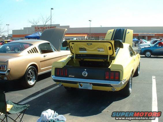Yellow 1970 Ford Mustang Mach 1 rear view with trunk open