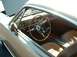 1995 Ford Crown Victoria - The interior of a classic Ford Mustang features a wood-grain steering wheel and two-tone seats.