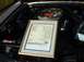 1995 Ford Crown Victoria - A framed window sticker for a Ford Mustang is displayed in the engine bay of a vehicle.