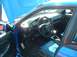 1995 Ford Crown Victoria - Interior view of a blue car with the hood open, showing the dashboard and seats.
